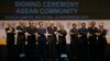 Laos' Prime Minister Thongsing Thammavong, in the middle of Asean leaders as they join their hands to pose for photographers after the signing ceremony of the 2015 Kuala Lumpur Declaration on the Establishment of the Association of Southeast Asian Nations (ASEAN) Community and the Kuala Lumpur Declaration on ASEAN 2025, in Kuala Lumpur, Malaysia, Sunday, Nov. 22, 2015. (AP Photo/Lai Seng Sin)