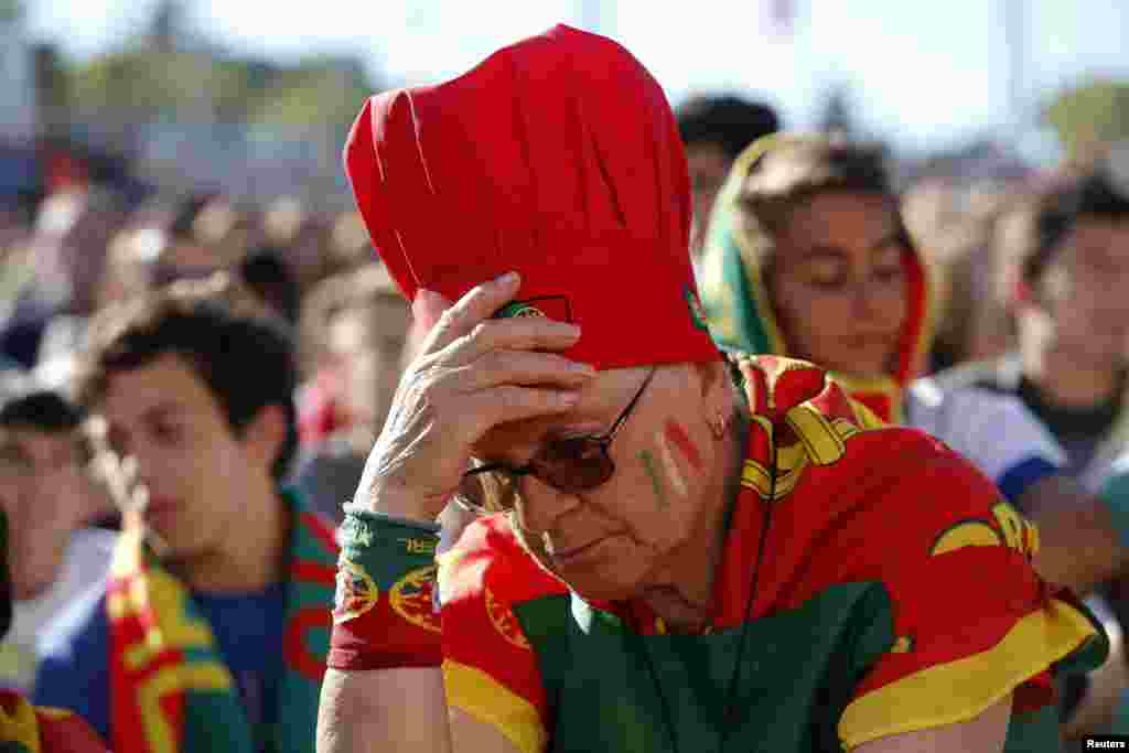 A Portugal fan reflects the general mood of the crowd at a public screening in Lisbon, June 26, 2014.