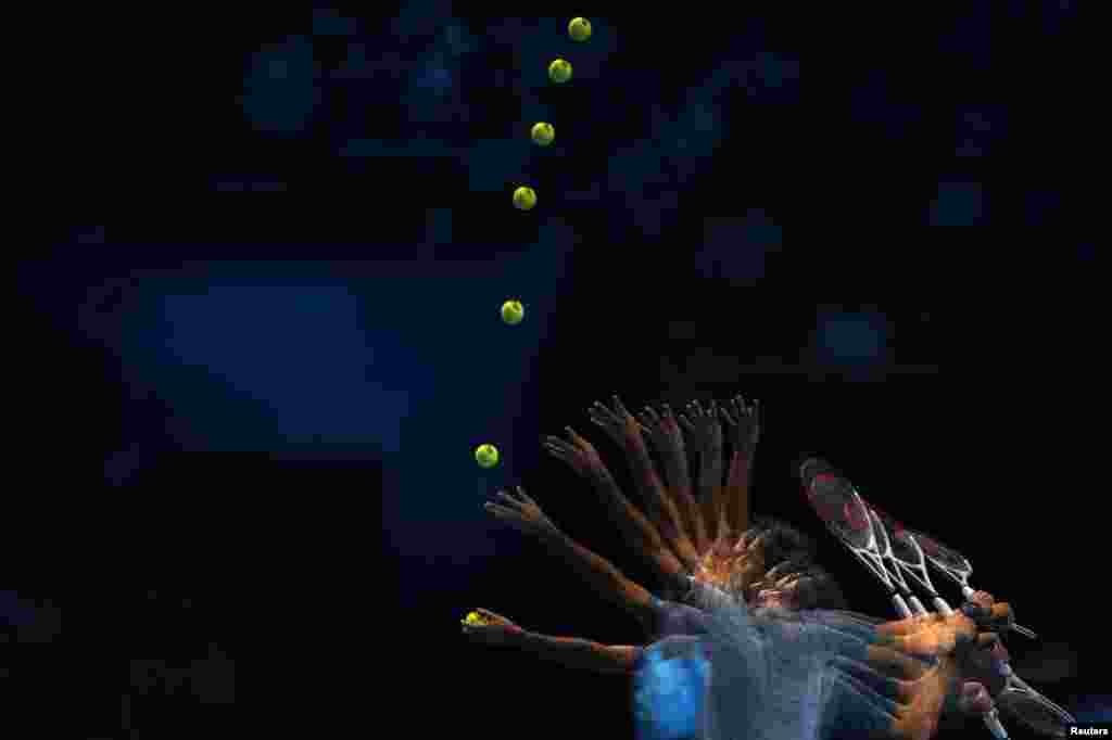 Roger Federer of Switzerland serves to Richard Gasquet of France during the men's singles tennis match at the ATP World Tour Finals at the O2 Arena in London.