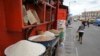 Local and imported rice is sold from bowls in front of a shop in Obalende market in Lagos, Nigeria, March 3, 2016. (C. Stein/VOA)