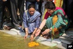 Congress party General Secretary and eastern Uttar Pradesh state in-charge Priyanka Gandhi Vadra, right, prays at the Sangam, the confluence of sacred rivers the Yamuna, the Ganges and the mythical Saraswati, in Prayagraj, India, March 18, 2019.