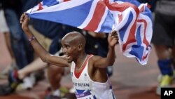 Britain's Mo Farah celebrates winning gold in the men's 10,000-meter final during the athletics in the Olympic Stadium at the 2012 Summer Olympics, London, August 4, 2012.