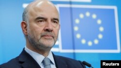 FILE - European Commissioner for Economic and Financial Affairs Pierre Moscovici attends a news conference at the end of a eurozone finance ministers meeting in Brussels, Belgium, Dec. 4, 2018. 