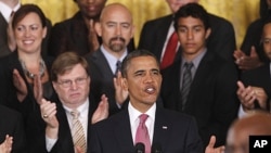 President Barack Obama stands with educators and students as he speaks about No Child Left Behind Reform, September 23, 2011, in the East Room of the White House in Washington.
