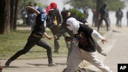 Protestors throw stones at police as during a demonstration where thousands of students gathered to demand fundamental changes in education policies in Santiago, Chile, September 22, 2011.