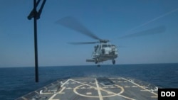 FILE - A SH-60 Seahawk helicopter takes off from the flight deck of USS Jason Dunham during a joint exercise with the Montenegrin navy March 16, 2015 in the Mediterranean Sea.