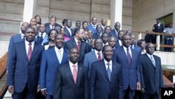 The new Ivory Coast government pose with President Alassane Ouattara after a council, at the Presidential Palace in Abidjan June 3, 2011