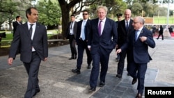 British Foreign Secretary Boris Johnson and Argentine Foreign Minister Jorge Faurie walk after paying homage to Argentine soldiers who died in the 1982 conflict between Britain and Argentina at the memorial dedicated to them in downtown Buenos Aires, Arge