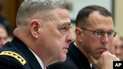 FILE - Army Chief of Staff Gen. Mark A. Milley, accompanied by Chief of Naval Operations Adm. John M. Richardson, testifies on Capitol Hill in Washington, April 5, 2017.
