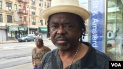 New Yorker Buddy Barrett reflects on events a year ago in Ferguson, Missouri while waiting for a bus at Amsterdam and 125th Street in Harlem