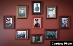 Four generations of U.S.-based soldiers, police officers and firefighters are on display inside the living room of Kieran O’Sullivan, an immigration counselor at the Irish Pastoral Centre of Boston. (Photo courtesy of Kieran O’Sullivan)