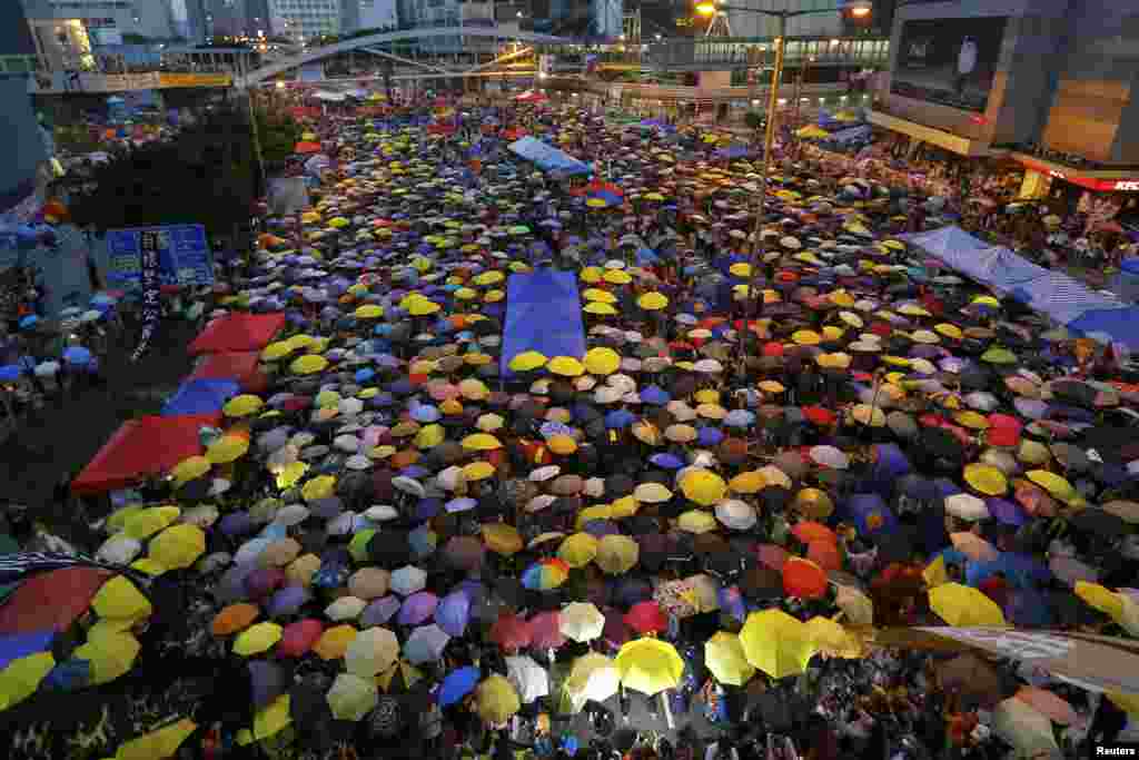 Protesters open their umbrellas, symbols of the pro-democracy movement, as they mark exactly one month since they took to the streets, in the financial district,&nbsp;Hong Kong, Oct. 28, 2014. 