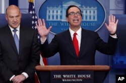 Treasury Secretary Steven Mnuchin, right, joined by National Economic Director Gary Cohn, discusses Trump's tax proposal in the White House in Washington, Wednesday, April 26, 2017.