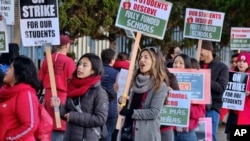 Striking Los Angeles Unified District teachers are joined by parents and students in front of Evelyn Thurman Gratts Elementary School in Los Angeles, Jan. 22, 2019. A tentative deal was reached Tuesday.