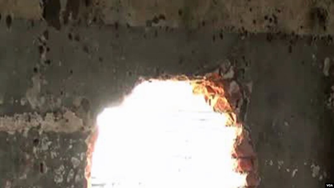 Men's prison in Goma. In the chaos that followed, more than 1,500 men, criminals, escaped from this prison, many of them through this hole in the wall.