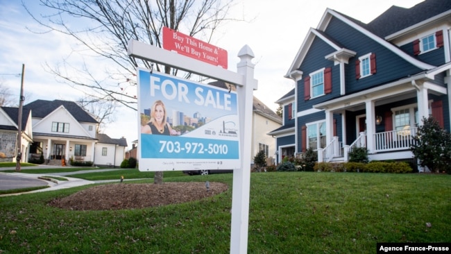 FILE - A for sale sign is seen in front of a home in Arlington, Va., Nov. 19, 2020.