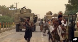 A still image taken from video provided by Arab 24 shows Saudi-led forces gathering to retake the international airport of Yemen's rebel-held port city of Hodeida from the Shiite Houthi rebels, June 16, 2018.