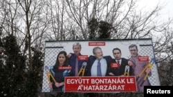 FILE - A government billboard shows George Soros (C) and opposition party leaders in Budapest, Hungary, Feb. 20, 2018. The billboard reads: 'They would dismantle the border fence together.'