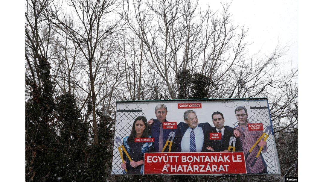 FILE - A government billboard shows George Soros (C) and opposition party leaders in Budapest, Hungary, Feb. 20, 2018. The billboard reads: 'They would dismantle the border fence together'.