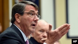 Defense Secretary Ash Carter, left, testifies before the House Armed Services Committee on Capitol Hill in Washington, June 17, 2015. Joint Chiefs of Staff Chairman Gen. Martin Dempsey listens at right.