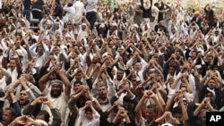 Anti-government protesters shout slogans during a rally after Friday prayers to demand the ouster of Yemen's President Ali Abdullah Saleh in Sana'a, June 24, 2011