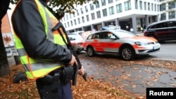 A German police officer guards the site where earlier a man injured several people in a knife attack in Munich, Germany, Oct. 21, 2017.