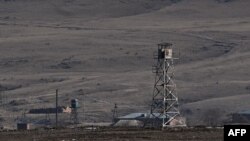 FILE - Armenian border guard towers are seen near the Turkish-Armenian border in the ancient city of Ani in Kars, Jan. 7, 2022. 