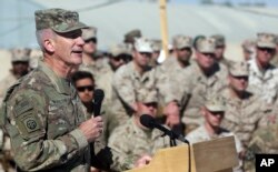 FILE - The commander of NATO and U.S. forces in Afghanistan, U.S. Army Gen. John W. Nicholson speaks during a change of command ceremony at Task Force Southwest atn Shorab military camp of Helmand province, Afghanistan, Jan. 15, 2018.