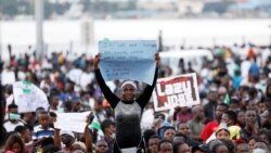 Nigeria, Lagos, A demonstrator holds a sign during protest over alleged police brutality