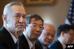 The Chinese delegation, including Vice Premier Liu He (L) and Governor of the People's Bank of China Yi Gang (2nd L) looks on during U.S.-China trade talks in Washington, Jan. 30, 2019.