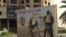 A poster on Baghdad street calls for volunteers to join the Hashd al-Shaabi militia, May 18, 2016. (S. Behn/VOA)
