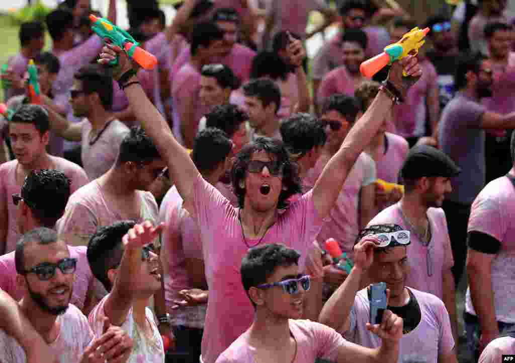 Iraqi youths holding water guns take part in the &quot;Festival of Colors&quot; organized in Baghdad in support of Iraqi troops and Popular Mobilization Units fighting against the Islamic State (IS) group.