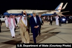 U.S. Secretary of State John Kerry, right, walks with Saudi Arabia Foreign Minister Adel al-Jubeir, at Jeddah International Airport in Jeddah, Saudi Arabia, May 14, 2016.