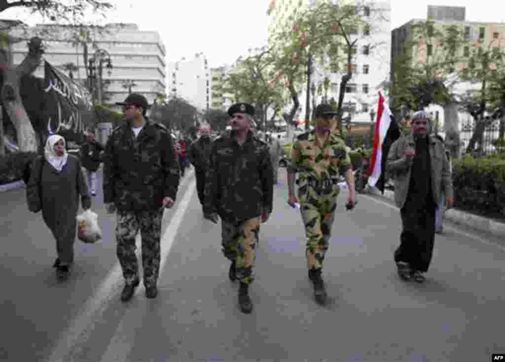 An Egyptian Major-General, center, walks with his officers outside the Egyptian Parliament in Cairo, Egypt, Wednesday, Feb. 9, 2011. Around 2,000 protesters waved huge flags outside the parliament, several blocks from Tahrir Square, where they moved a day