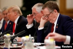 U.S. Trade Representative Robert Lighthizer, right, and U.S. Secretary of State Rex Tillerson, second right, attend bilateral meetings between U.S. President Donald Trump and China's President Xi Jinping at the Great Hall of the People in Beijing, Nov. 9, 2017.
