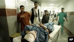 A man injured in a roadside bomb blast lies on a stretcher in a hospital in Herat, west of Kabul, 18 Oct 2010