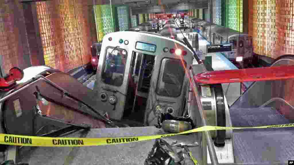 A Chicago Transit Authority train car rests on an escalator at the O&#39;Hare Airport station after it derailed.