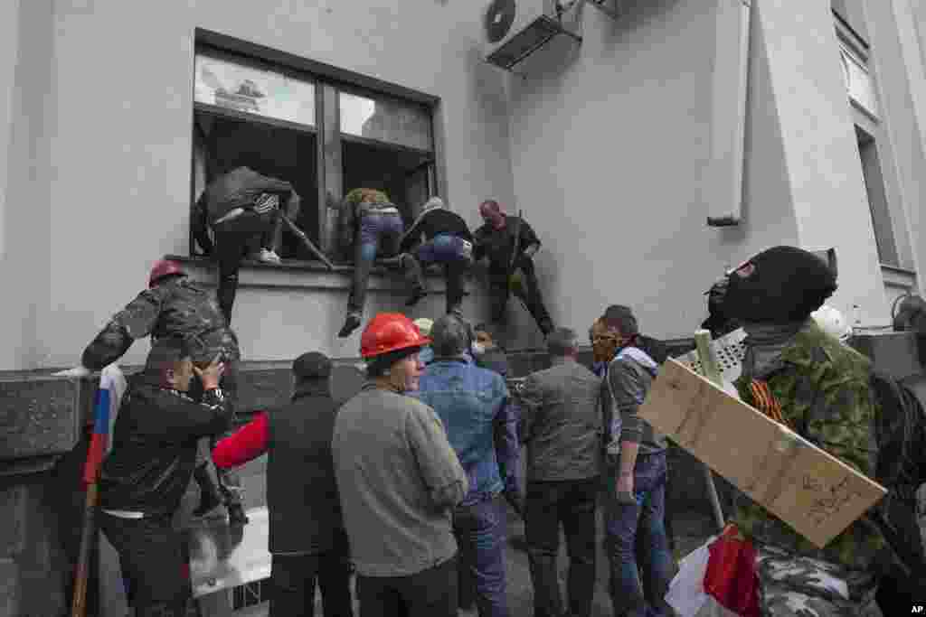 Pro-Russian activists storm an administration building in the center of Luhansk, Ukraine, April 29, 2014.