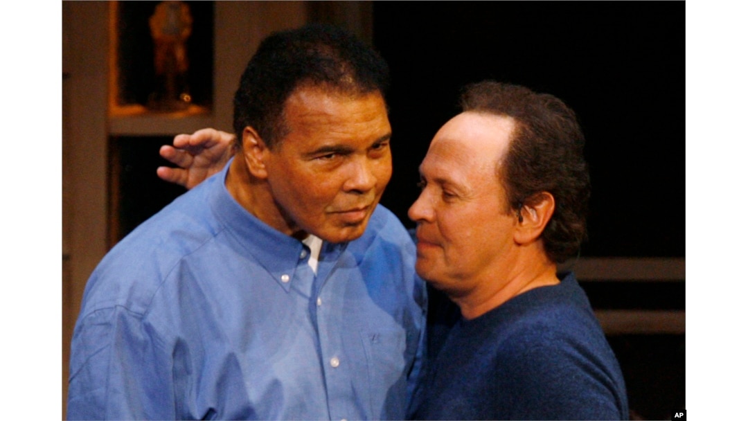 FILE - Comedian Billy Crystal, right, hugs boxing legend Muhammad Ali on his 65th birthday on the campus of Arizona State University in Tempe, Ariz., Jan. 17, 2007. Crystal is expected to speak at Ali's funeral in Louisville, Ky., June 10, 2016.