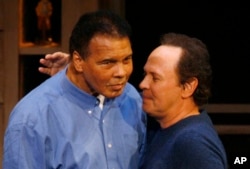 FILE - Comedian Billy Crystal, right, hugs boxing legend Muhammad Ali on his 65th birthday on the campus of Arizona State University in Tempe, Ariz., Jan. 17, 2007. Crystal is expected to speak at Ali's funeral in Louisville, Ky., June 10, 2016.