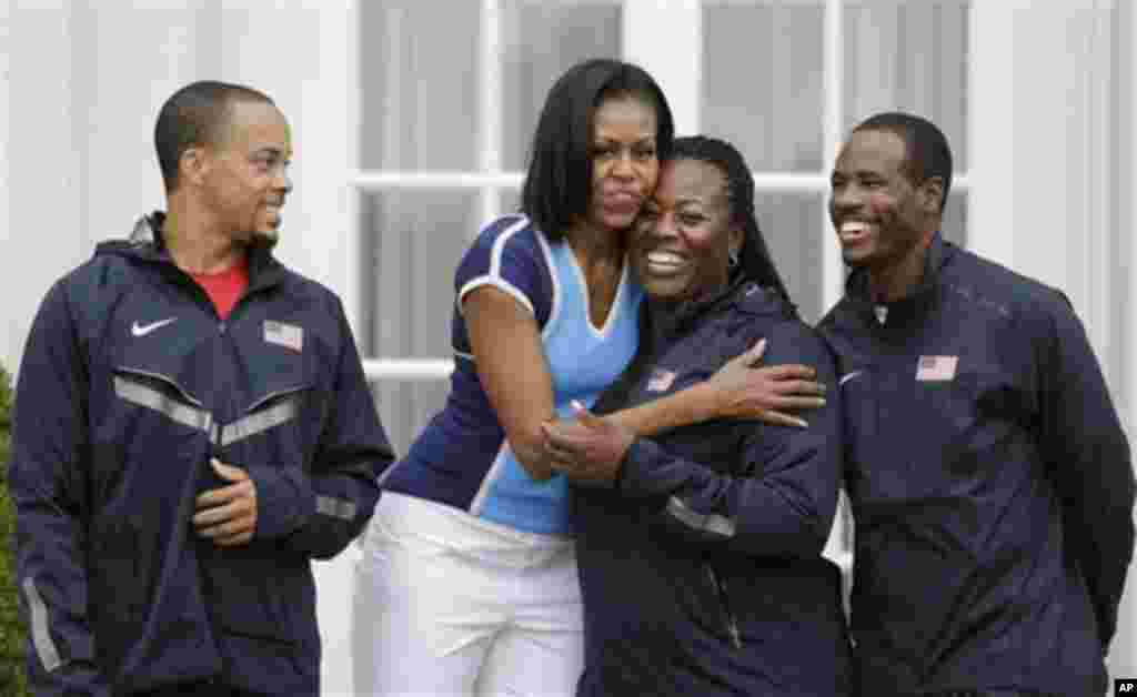 U.S. first lady Michelle Obama poses with members of the U.S. athletics team during a 'Let's Move!' event for about 1,000 American military children and American and British students at the U.S. ambassador's residence in London, ahead of the 2012 Summer O