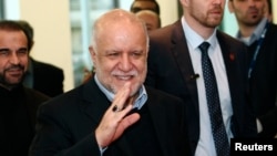 Iranian Oil Minister Bijan Zanganeh wave to journalists as he arrives for a meeting of OPEC oil ministers at OPEC's headquarters in Vienna, Austria, Dec. 4, 2013. 