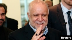 FILE - Iranian Oil Minister Bijan Zanganeh wave to journalists as he arrives for a meeting of OPEC oil ministers at OPEC's headquarters in Vienna, Austria, Dec. 4, 2013. 