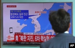 FILE - A man watches a TV news report about a possible nuclear test conducted by North Korea at the Seoul Railway station in Seoul, South Korea, Sept. 3, 2017.