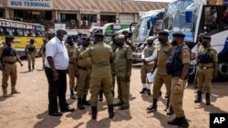 Ugandan police gather to inform people about terrorism risks and to increase security at Kisenyi bus terminal in the capital Kampala, Uganda, Oct. 26, 2021.