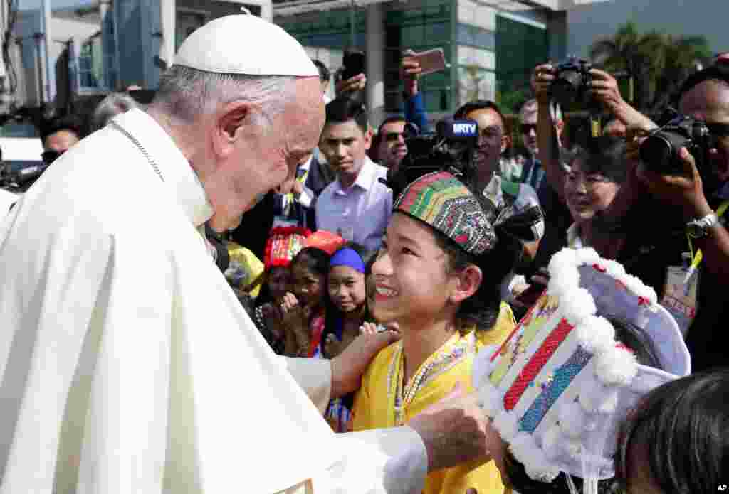 Pope Francis is welcomed at Yangon International Airport, Myanmar, Nov. 27, 2017.