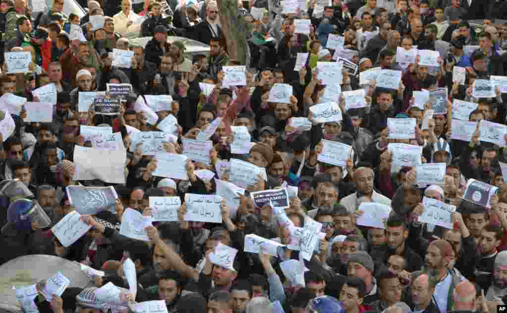 More than a thousand protesters thronged the streets of Algiers, Algeria denouncing cartoons of the Prophet Muhammad published by French satirical weekly Charlie Hebdo. Chanting &quot;I am not Charlie, I am Muhammad,&quot; protesters left their mosques after Friday prayers and gathered in May 1 square where they were met by hundreds of riot police.