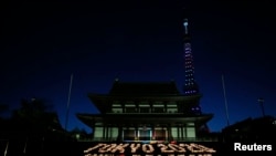 A message reading "Tokyo 2020 We Believe", made up of 2,020 candles, is displayed at Zojoji temple in Tokyo September 5, 2013. 