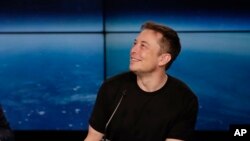 FILE- South Africa-born Elon Musk, founder, CEO, and lead designer of SpaceX and creator of electric car making Tesla, speaks at a news conference after the Falcon 9 SpaceX heavy rocket launched successfully from the Kennedy Space Center in Cape Canaveral