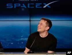 FILE- South Africa-born Elon Musk, founder, CEO, and lead designer of SpaceX and creator of electric car making Tesla, speaks at a news conference after the Falcon 9 SpaceX heavy rocket launched successfully from the Kennedy Space Center in Cape Canaveral